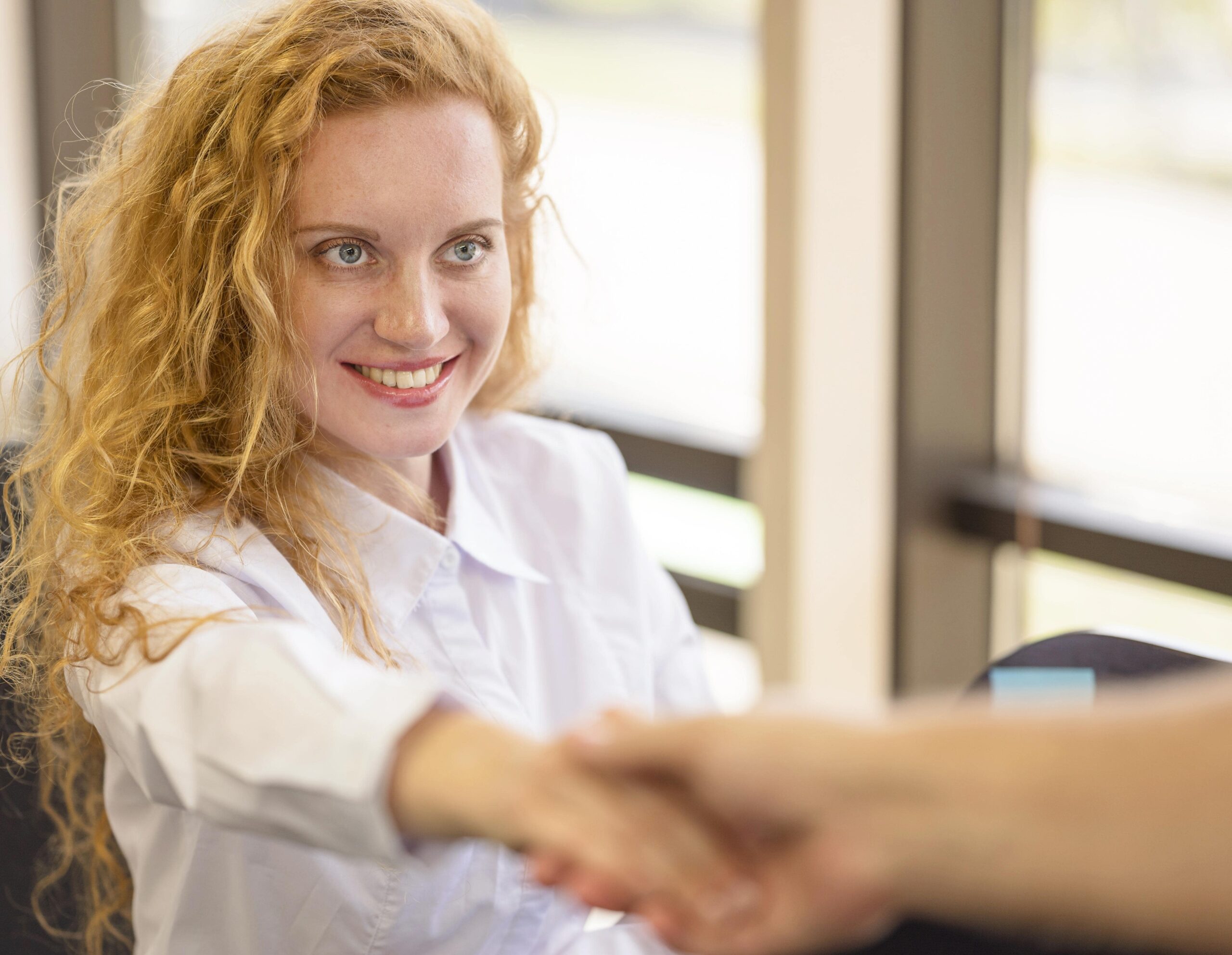 businesswoman-holding-hands-smiles-min